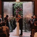 Flora Nova Design Seattle Luxe JM Cellars Wedding. Greenery Wall as Ceremony Backdrop: Smilax, Taper Candles, Candelabra, Burgundy, Red Roses