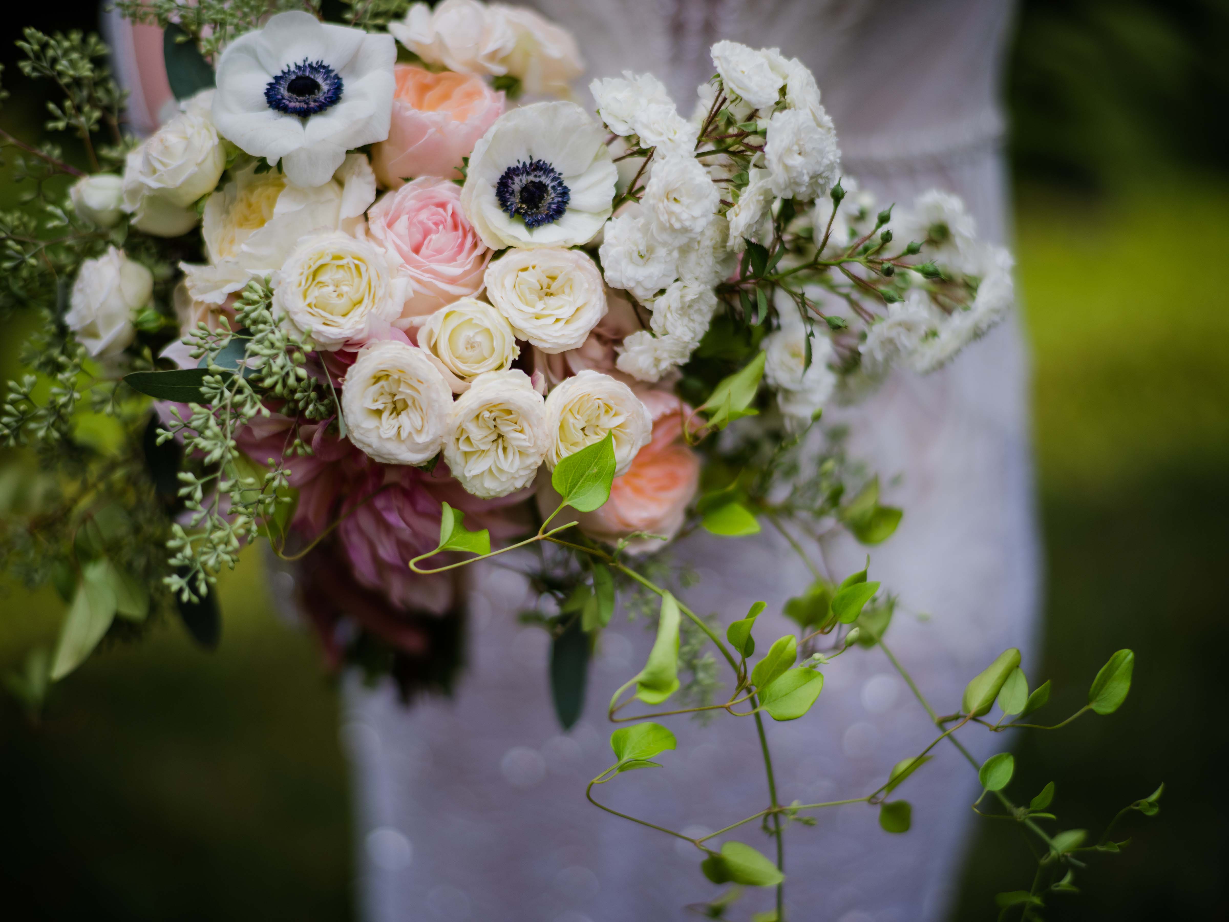 Pretty bridal bouquet of garden roses, garden spray roses, and anemones, designed by Flora Nova Design Seattle