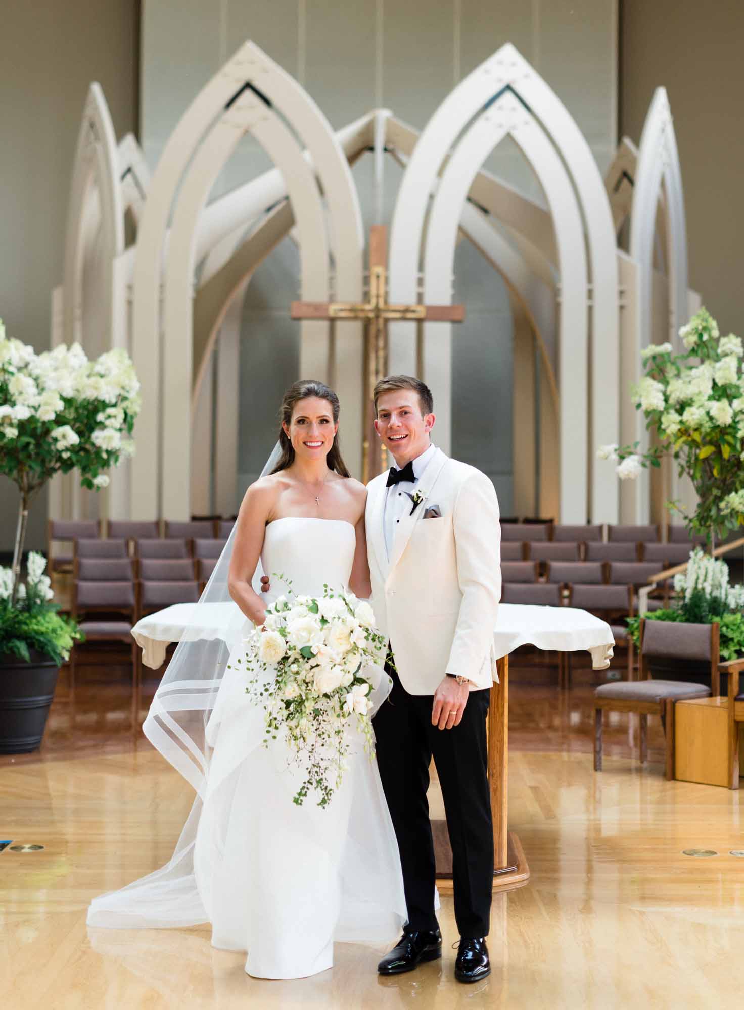 Bride and groom in front of church altar at their wedding