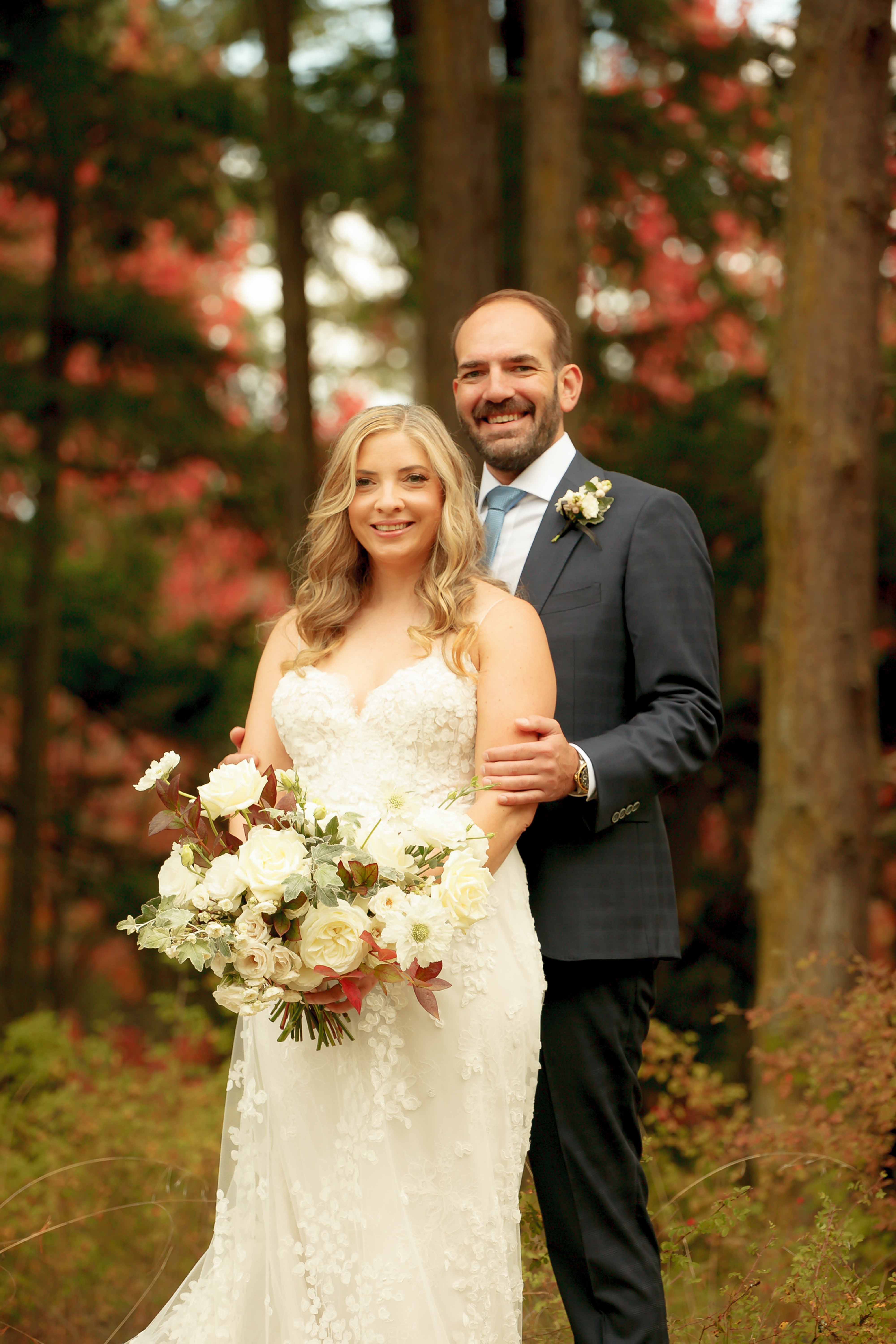 Beautiful wedding couple, bride holding bouquet of fall flowers, designed be Flora Nova Design
