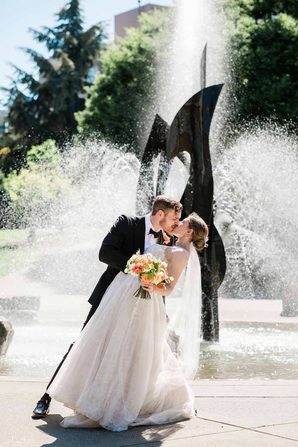 Bridal couple kissing their sunny summer wedding day in Seattle