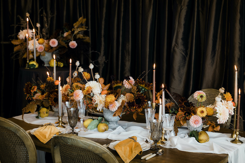 Decorating for the Holidays: Thanksgiving table with fresh flower centerpieces, decked with taper candles, mustard yellow napkins, wooden table, Provence chairs - FLORA NOVA DESIGN SEATTLE