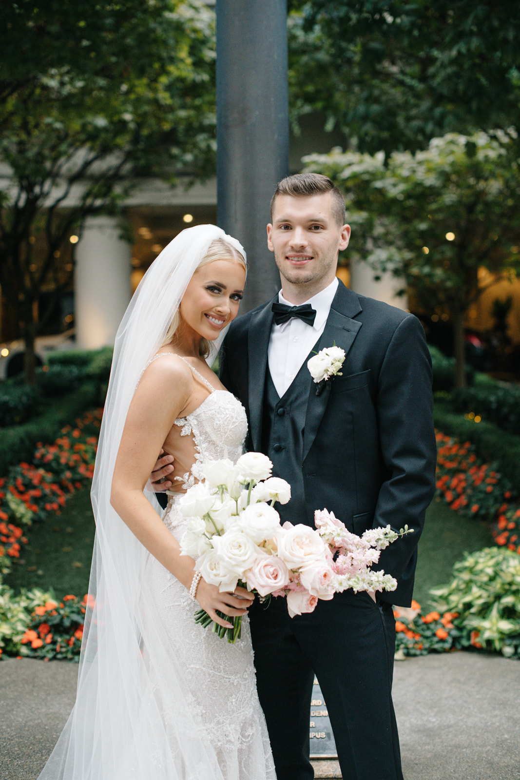 A bride and groom stand outside the Seattle Four Seasons for their First Look.