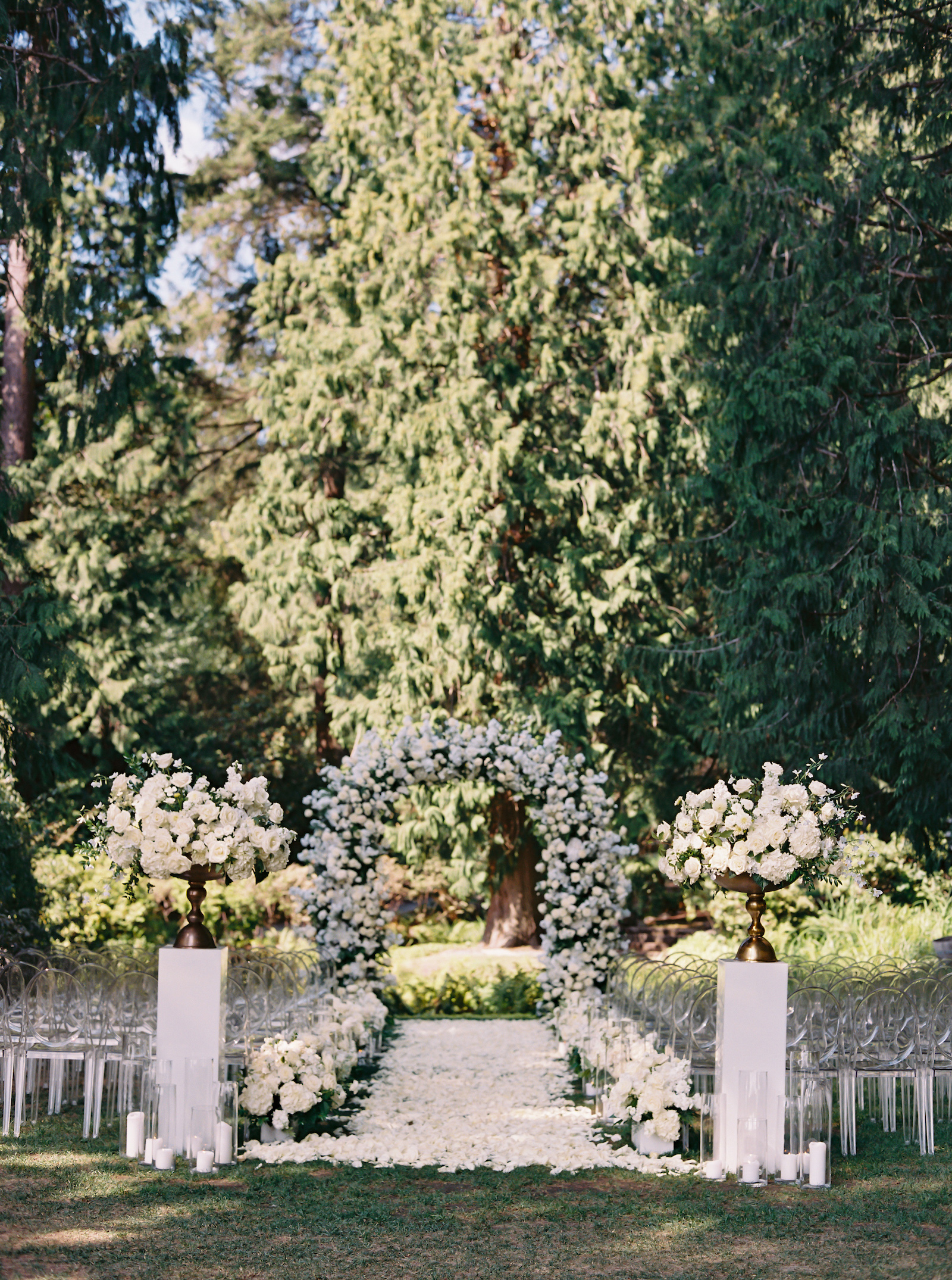 White wedding ceremony aisle and arch designed by Seattle Florist.