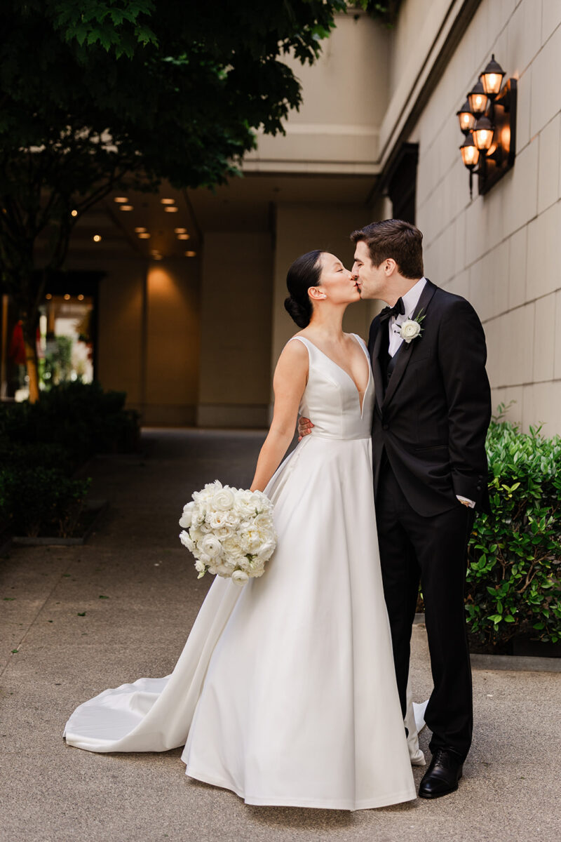 Bride and Groom kiss in front of the Fairmont Olympic Hotel in Seattle