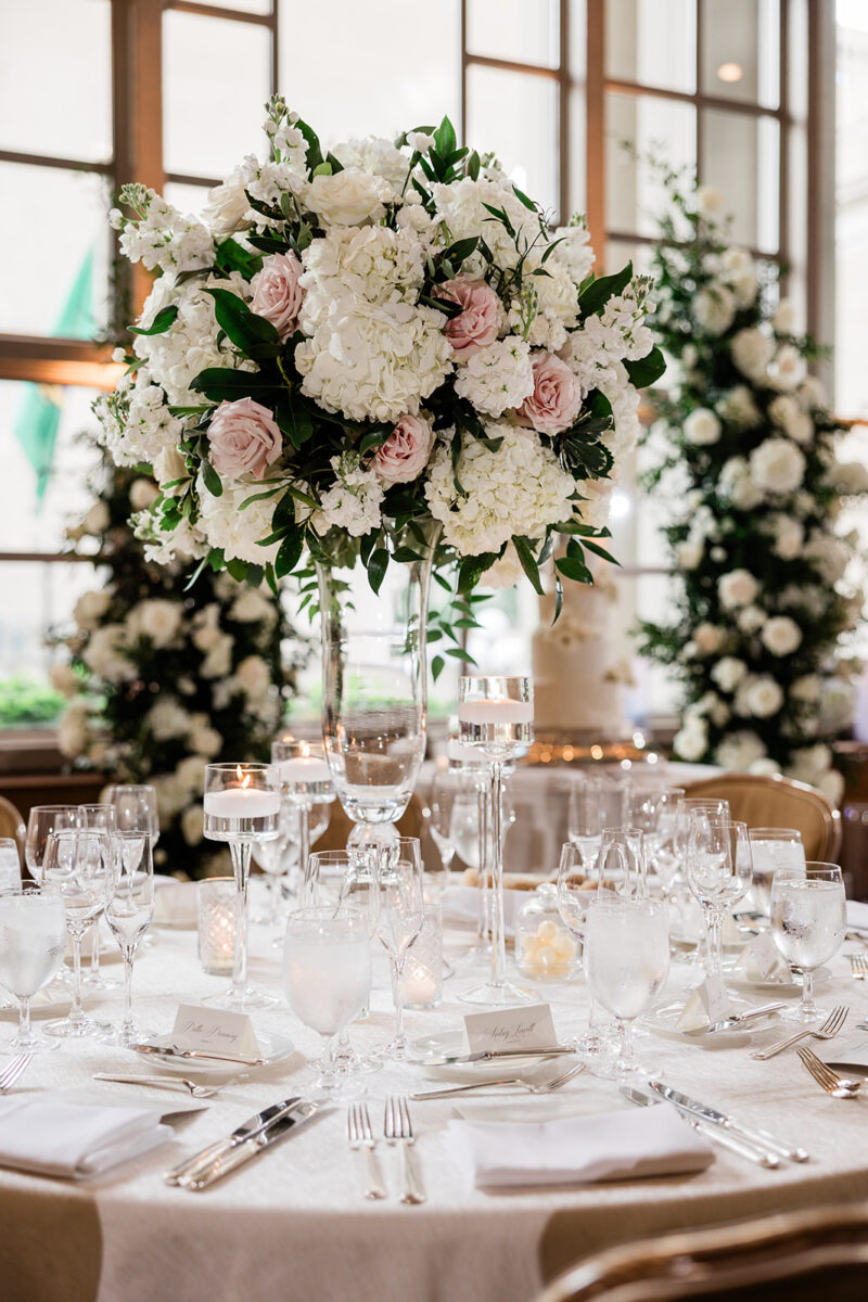 Tall lush white and blush floral arrangement decorate the reception tables in the Garden Room at Fairmont Olympic Hotel.