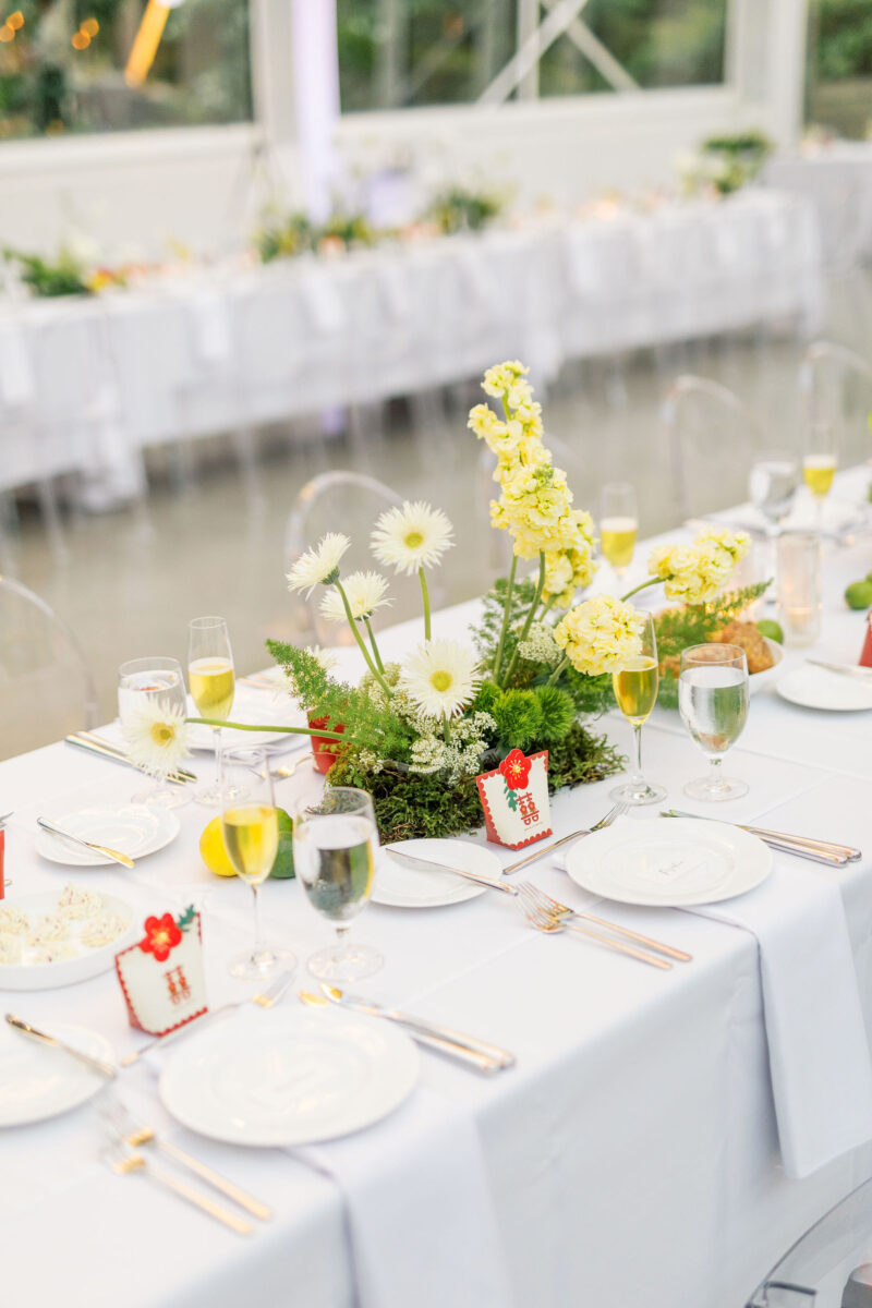 whimsical moss garden arrangements line the reception tables designed with greenery and white florals.
