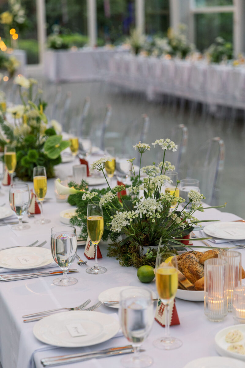 Green and white floral arrangements light the reception tables.