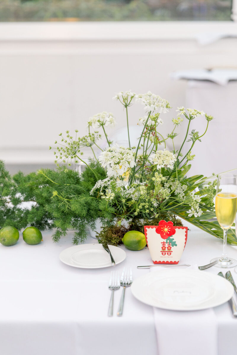Unique and vibrant green and white floral arrangements light the reception tables.