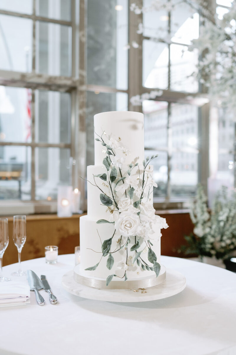 A lovely white 3 tiered cake with floral details.