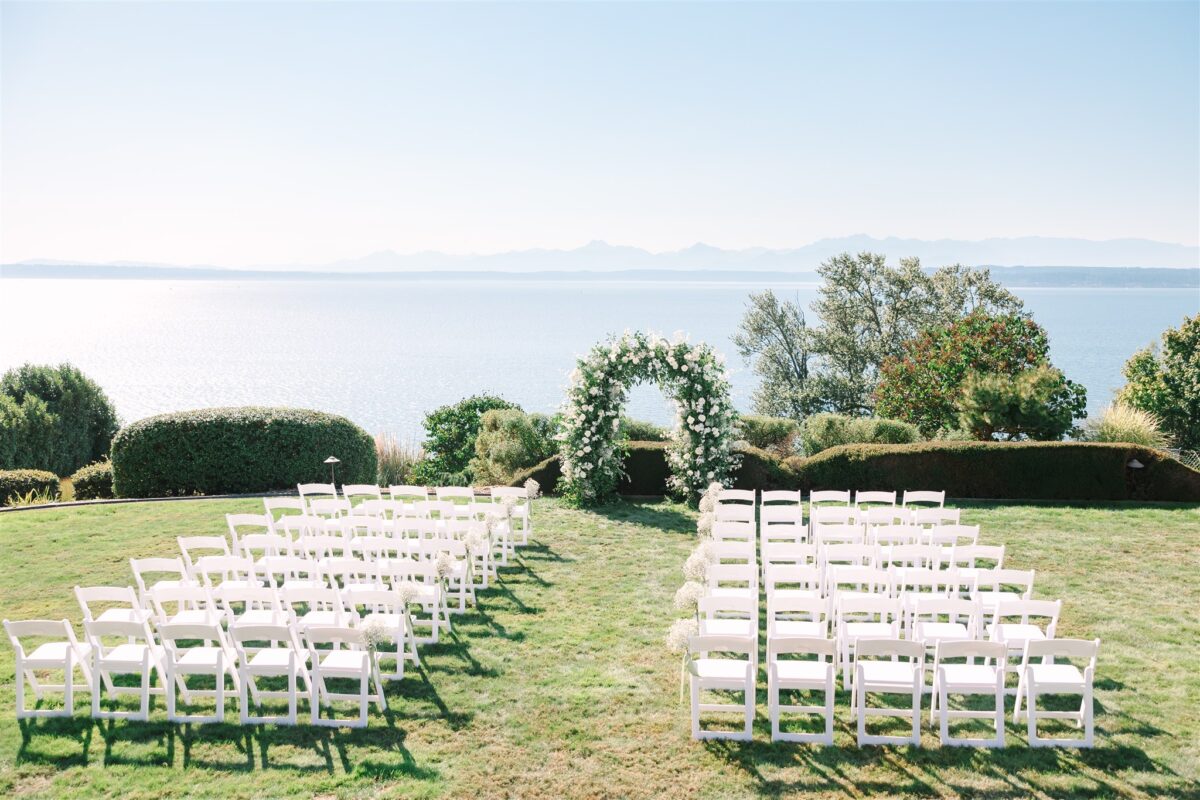 Ceremony takes place on the lawn at the glamorous wedding at a private residence, over looking the water and the Olympic mountain range.