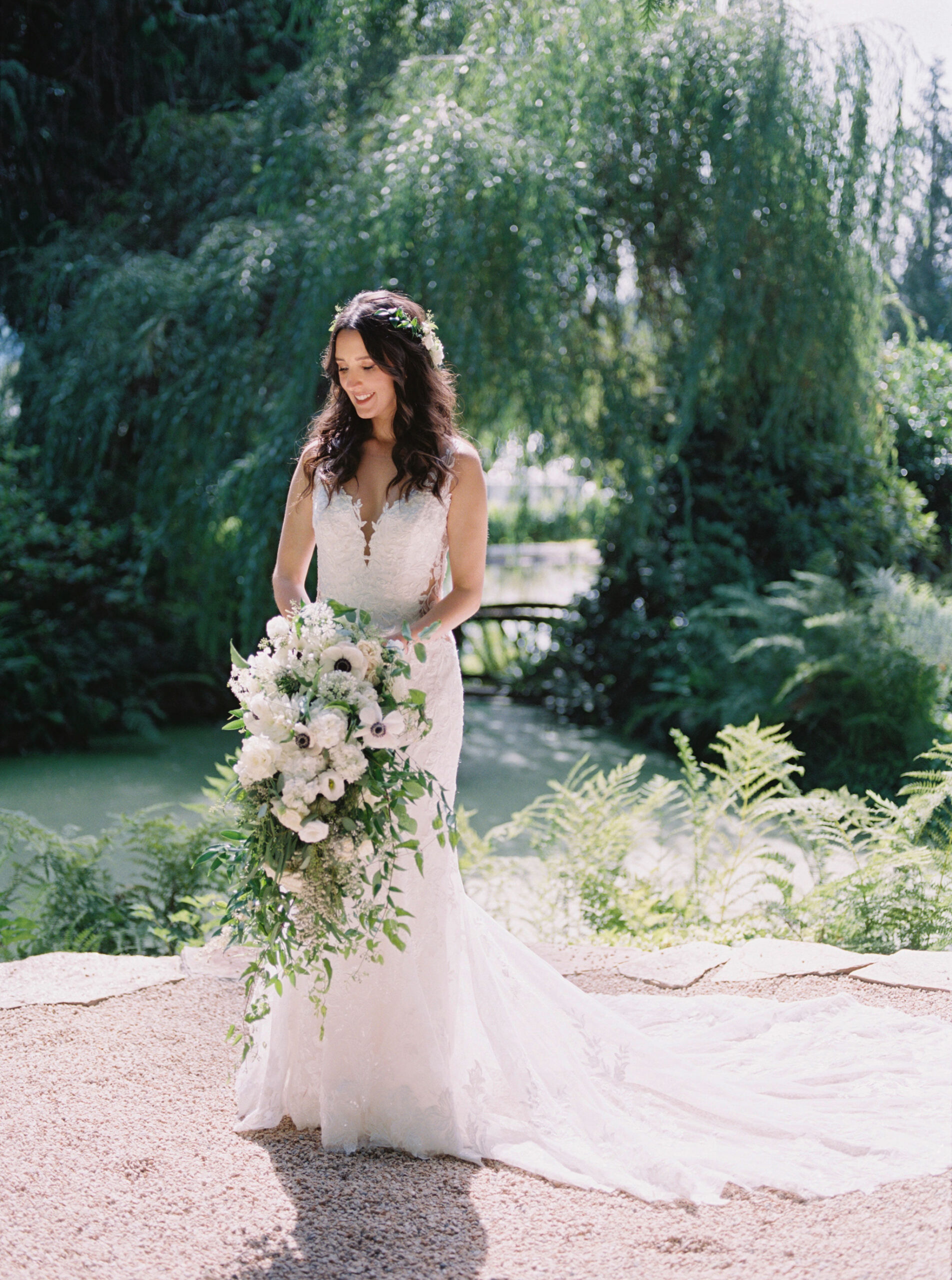 Bride holding her cascading bridal bouquet and wearing her floral crown designed by Seattle Florist.