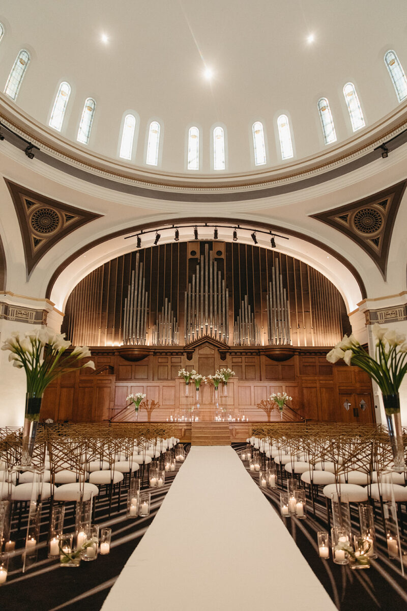 Ceremony aisle view showing symmetrical white calla lily arrangements at Elegant Hotel Lotte Wedding