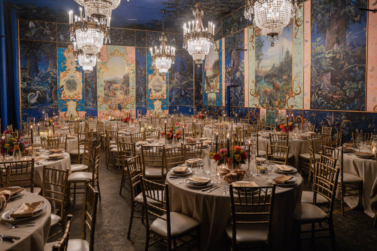 A colorful wedding at The Ruins featuring colorful floral abundant centerpieces and candlelight.
