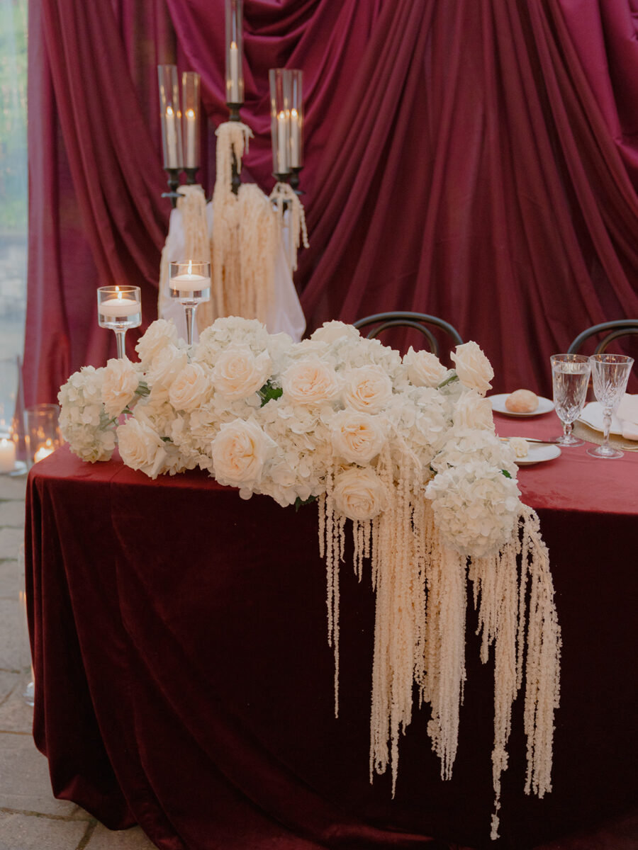 Sweet heart table focus on white roses, hanging dried amaranth and white hydrangea.
