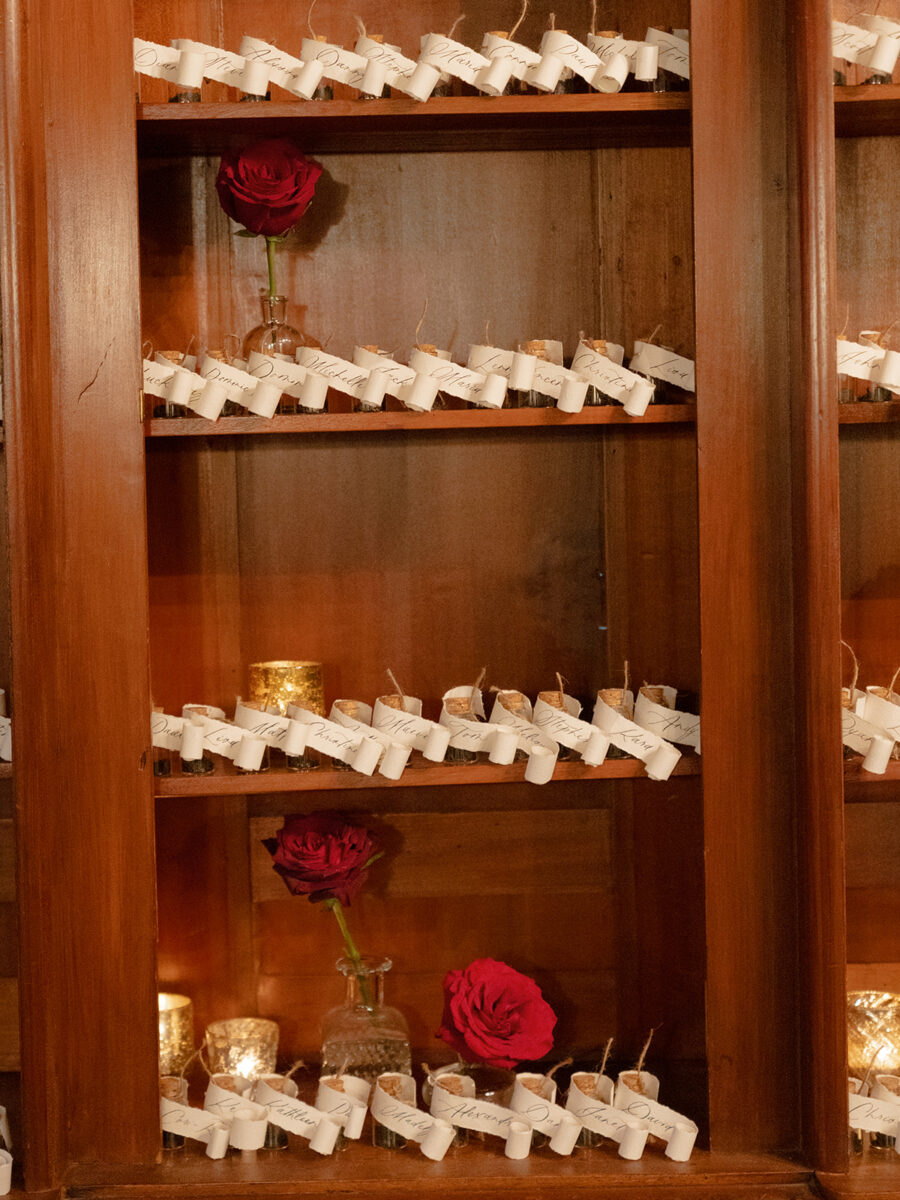 Guest seating chart was a creative display of mini poison bottles with guest names and table numbers, a nod to Romeo and Juliet.