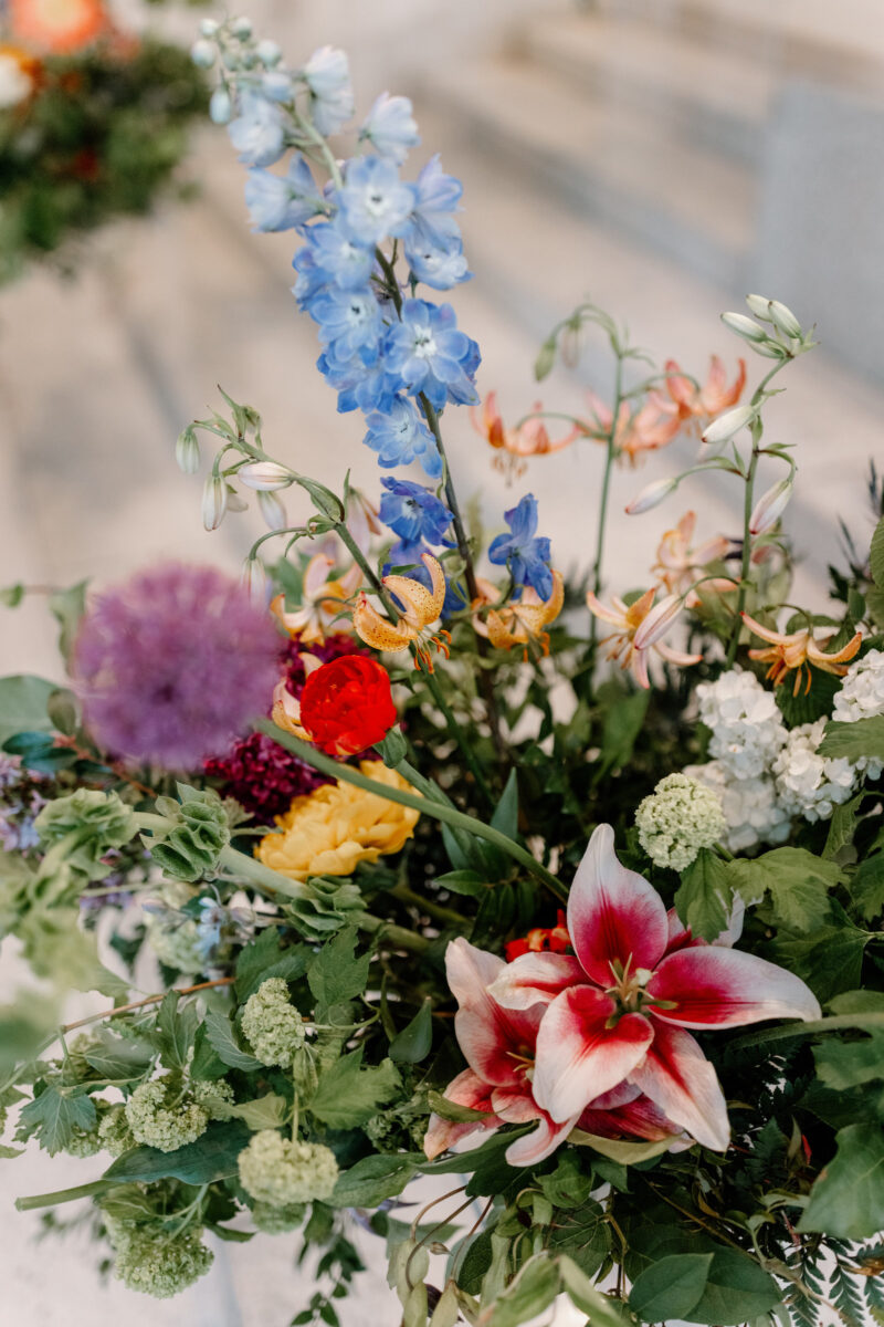 Closeup photo of colorful ceremony floral designs.