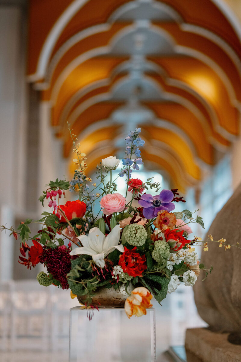 Aisle entrance floral design on a lucite pillar.