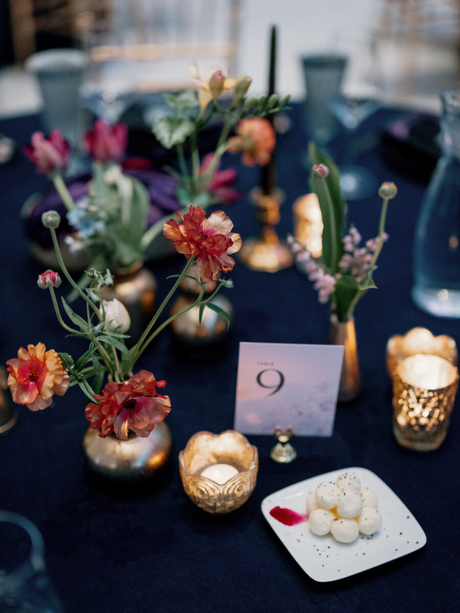 Bud vase style centerpieces in dark moody colors a Seattle Art Museum Wedding designed by Flora Nova Designs.